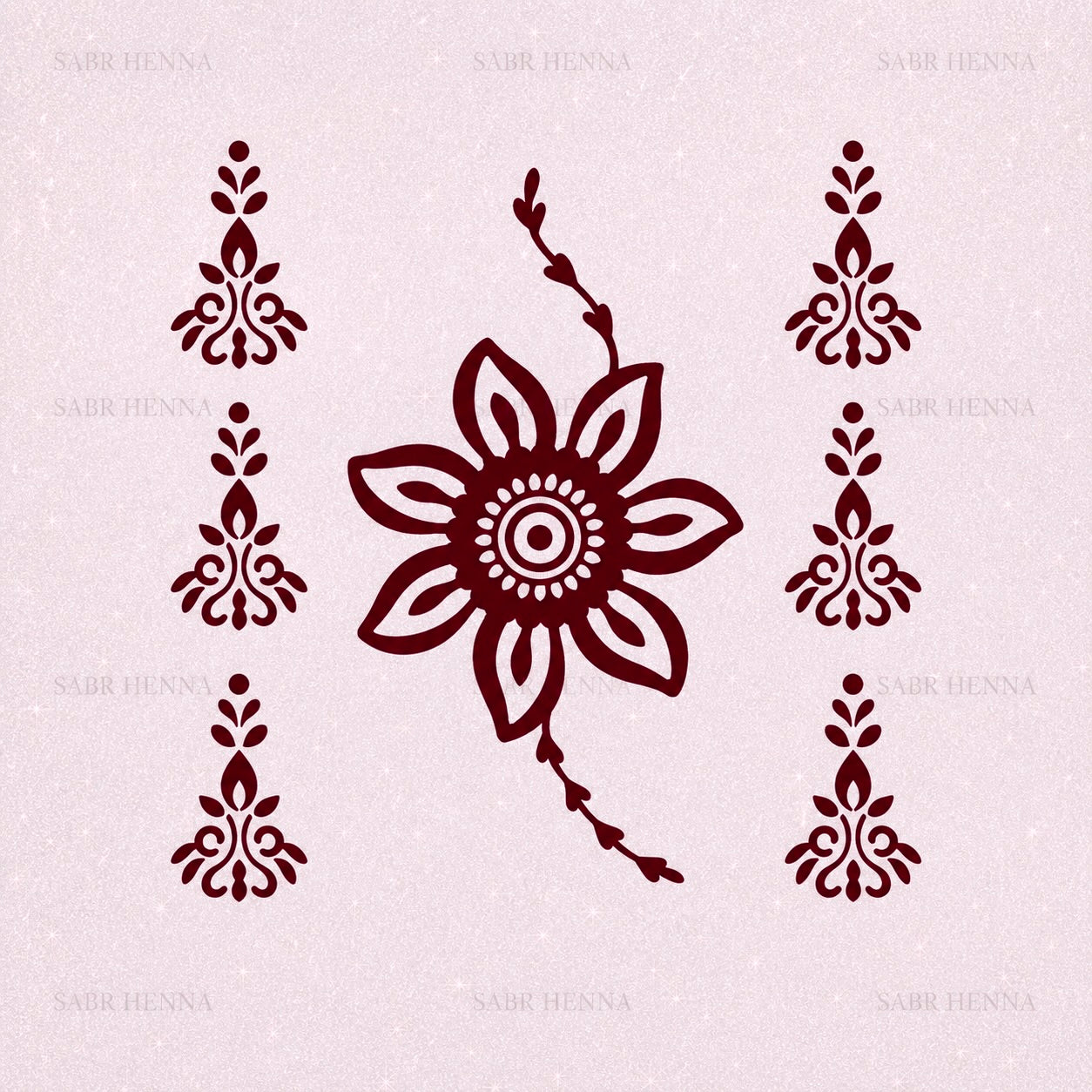 A digital graphic of a temporary tattoo sheet layout on a light gray, textured background with a faint "SABR HENNA" watermark. The center features a bold, deep maroon eight-petaled sunburst motif with trailing vine ends, flanked by six matching mini filigree droplet clusters arranged vertically on both sides.