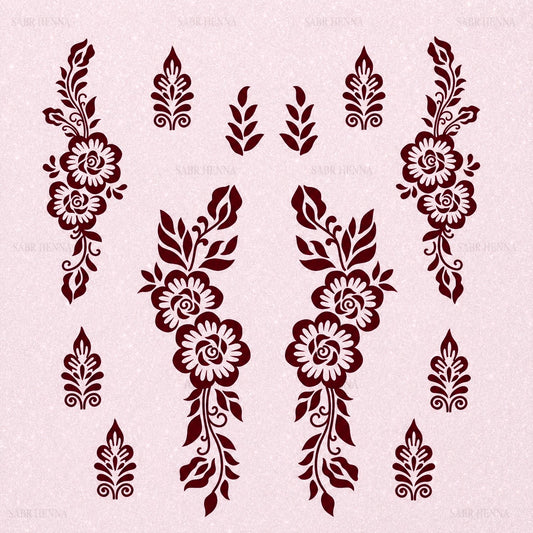 A square henna stencil sheet with a soft, light pink textured background. The sheet features multiple decorative designs arranged symmetrically. The central elements include two mirrored vertical floral patterns composed of three rose-like flowers connected by curved stems and surrounded by leaves. On the left and right sides are larger floral vine designs with similar rose and leaf elements extending vertically. Smaller motifs, including leaf clusters and ornamental teardrop-shaped patterns, are spaced.